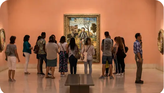 A group of tourist loonking at a painting in the Reina Sofía Museum in Madrid