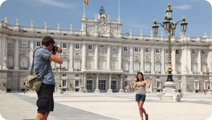 Couple taking photos at the Royal Palace of Madrid